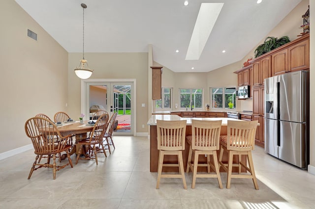 kitchen with stainless steel appliances, a skylight, visible vents, light countertops, and french doors