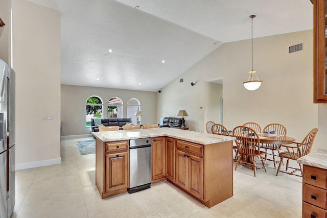 kitchen featuring open floor plan, vaulted ceiling, visible vents, and brown cabinets