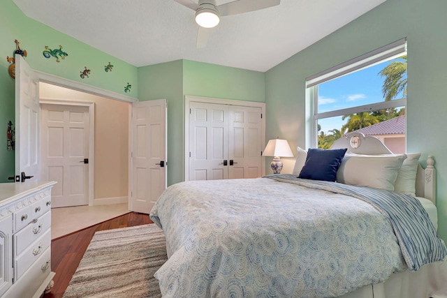 bedroom featuring ceiling fan, a closet, and wood finished floors