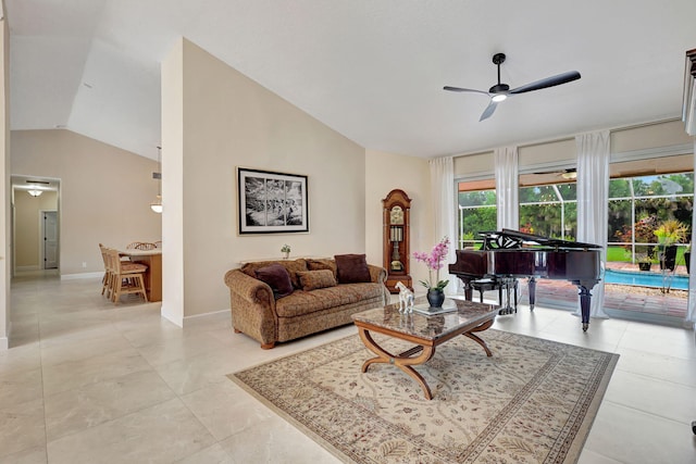 living area with vaulted ceiling, ceiling fan, light tile patterned flooring, and baseboards