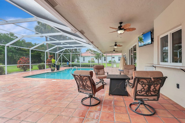 pool with ceiling fan, a patio, and glass enclosure