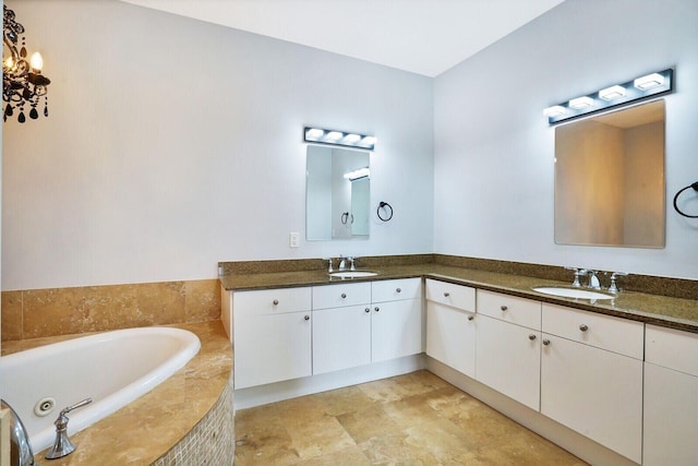 bathroom with a sink, a bath, and double vanity