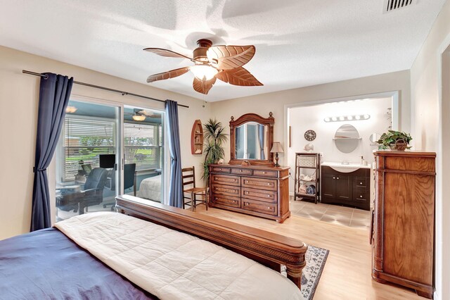 bedroom with a textured ceiling, ceiling fan, light wood-type flooring, and access to exterior