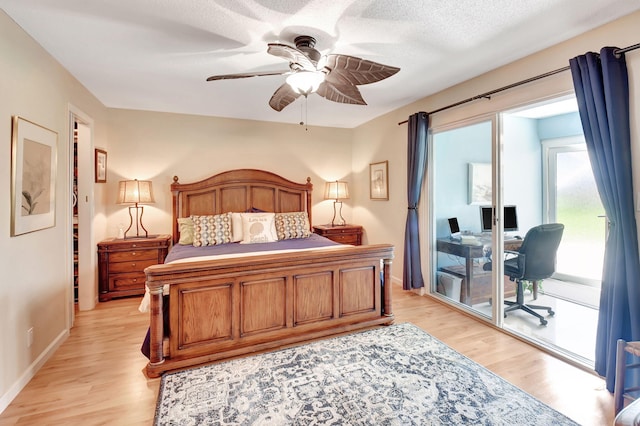 bedroom with light wood-style floors, ceiling fan, access to exterior, and a textured ceiling