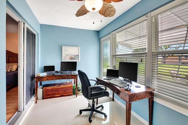 tiled office space featuring ceiling fan