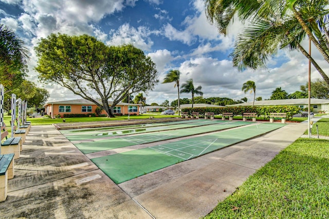 surrounding community with shuffleboard and a yard