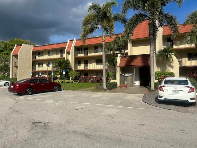 view of property featuring uncovered parking