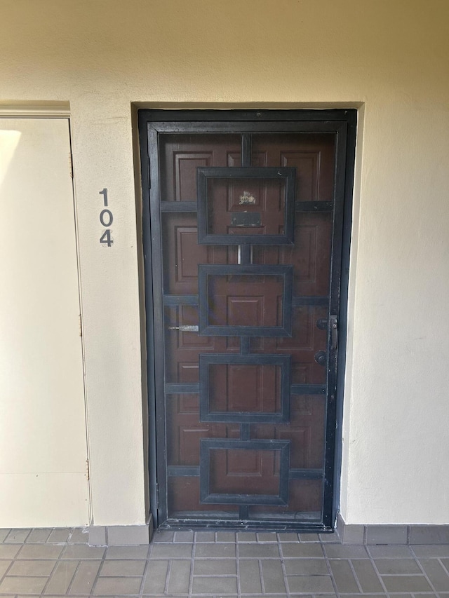 entrance to property with stucco siding