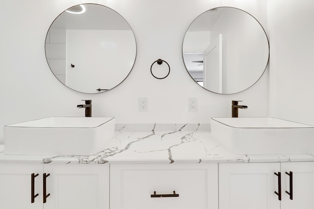 bathroom featuring a sink and double vanity