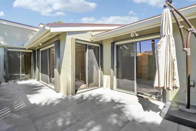 exterior space with a patio area and stucco siding