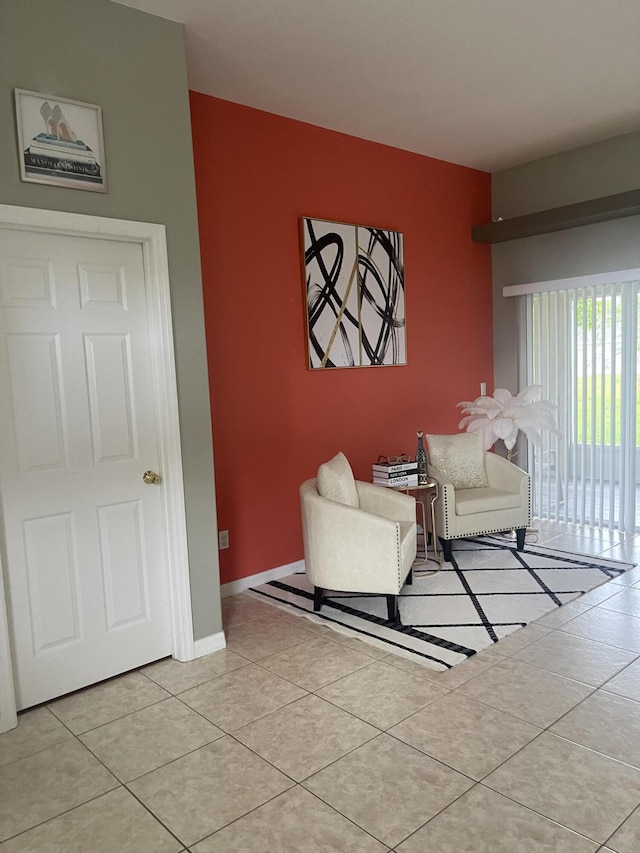 living room featuring light tile patterned flooring and baseboards