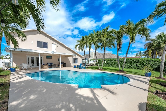 view of pool with a fenced in pool, an outdoor hangout area, fence, french doors, and a patio area