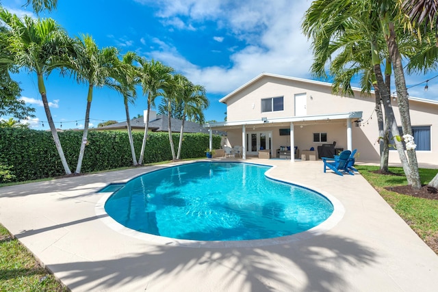 view of swimming pool featuring a fenced in pool, a patio area, fence, and an outdoor living space