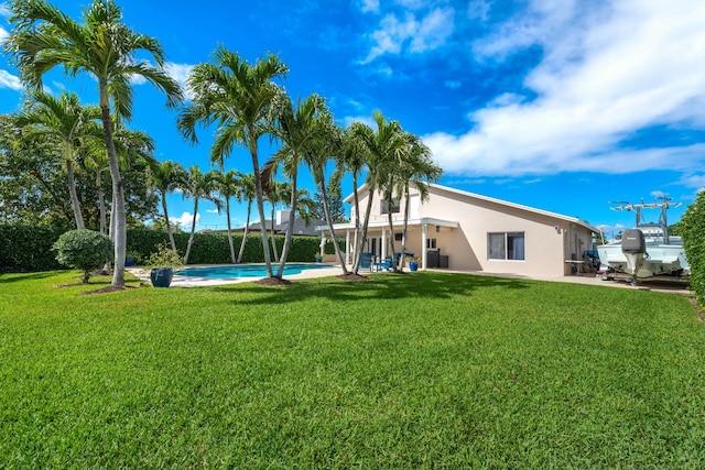 view of yard featuring an outdoor pool and a patio