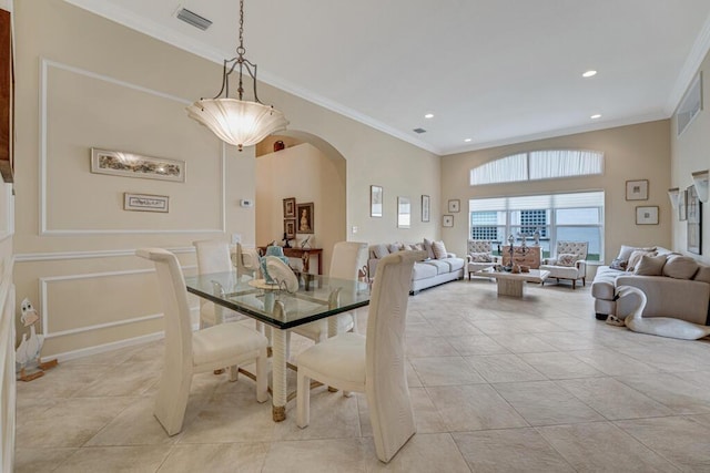 dining area with light tile patterned floors, visible vents, arched walkways, ornamental molding, and recessed lighting