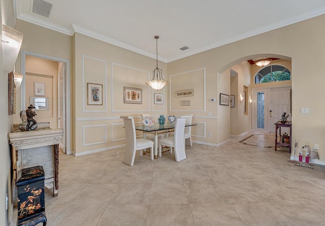 dining space featuring visible vents, arched walkways, ornamental molding, a decorative wall, and light tile patterned flooring