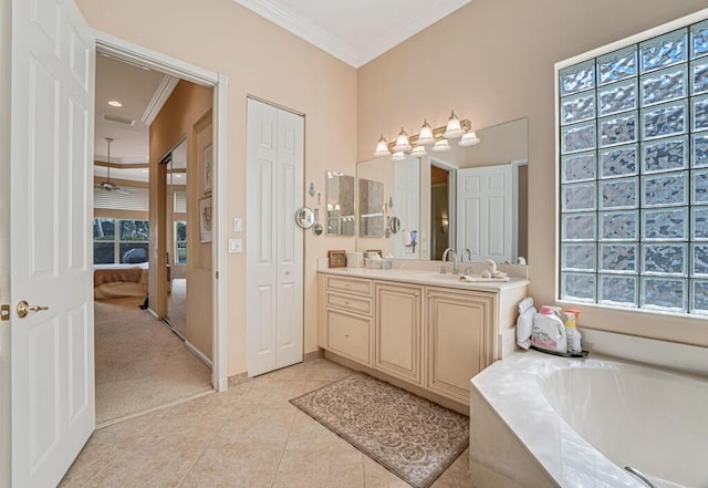 ensuite bathroom featuring ornamental molding, ensuite bathroom, tile patterned flooring, vanity, and a bath