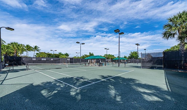 view of sport court featuring fence