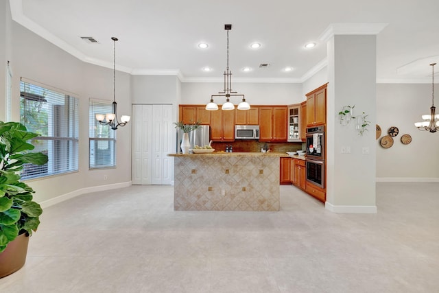 kitchen featuring brown cabinets, a notable chandelier, visible vents, appliances with stainless steel finishes, and baseboards