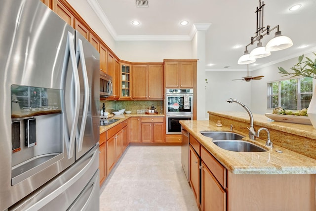 kitchen with light stone counters, stainless steel appliances, a sink, ornamental molding, and decorative backsplash