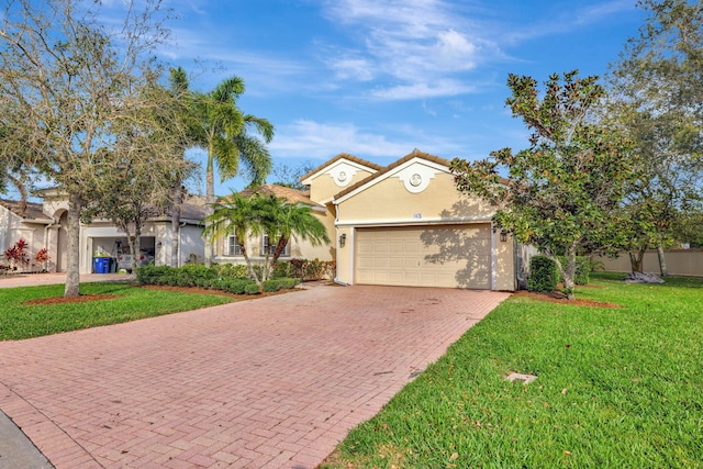 ranch-style house with a garage, a tiled roof, decorative driveway, stucco siding, and a front yard