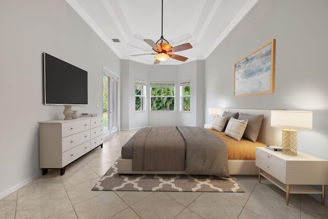 bedroom with a tray ceiling, light tile patterned flooring, crown molding, and baseboards