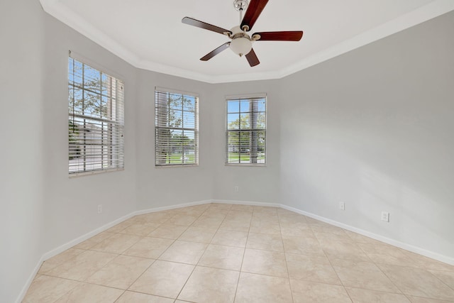 unfurnished room with baseboards, ornamental molding, a ceiling fan, and light tile patterned flooring