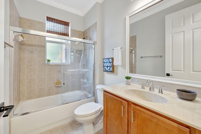 bathroom featuring toilet, enclosed tub / shower combo, ornamental molding, tile patterned flooring, and vanity