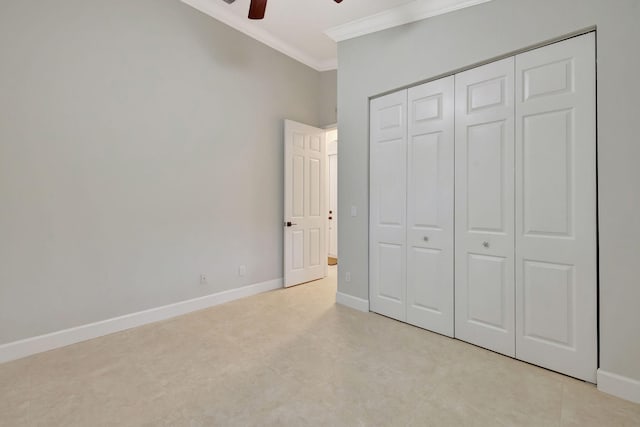 unfurnished bedroom featuring ornamental molding, a closet, baseboards, and a ceiling fan