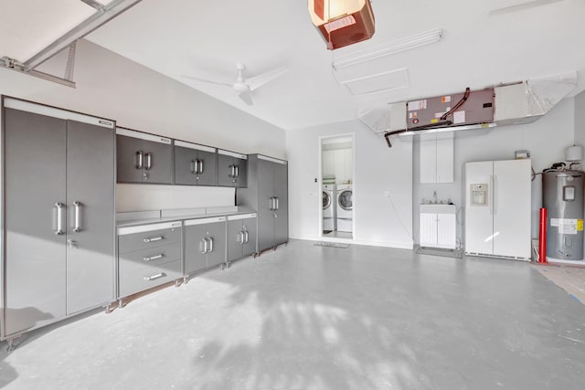 garage with a garage door opener, a ceiling fan, electric water heater, white fridge with ice dispenser, and independent washer and dryer