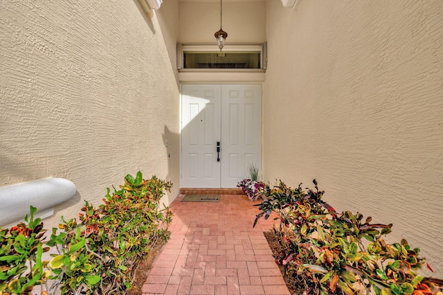 doorway to property with stucco siding