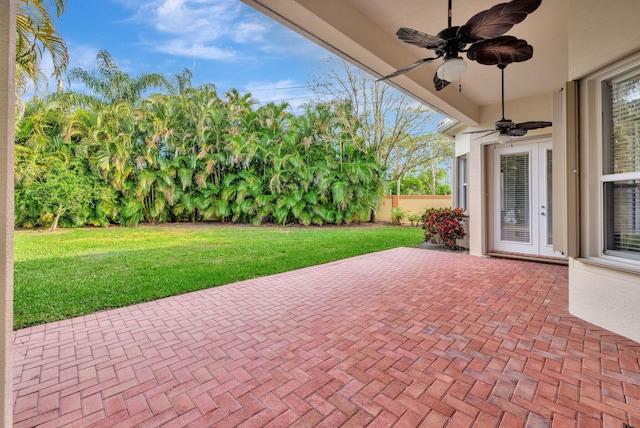 view of patio featuring ceiling fan and fence