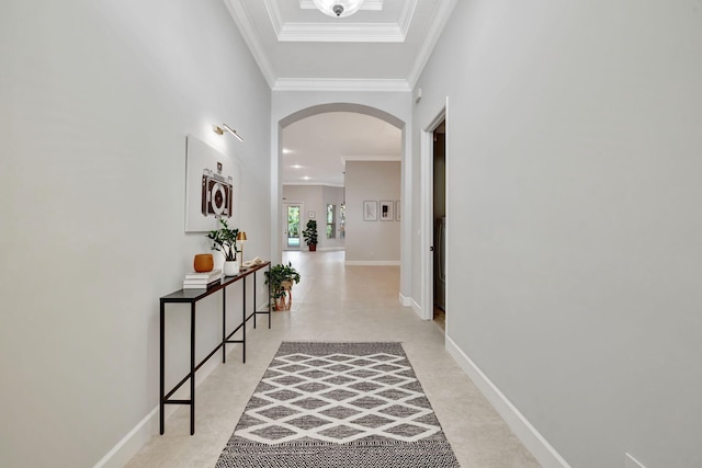 corridor featuring baseboards, arched walkways, and crown molding