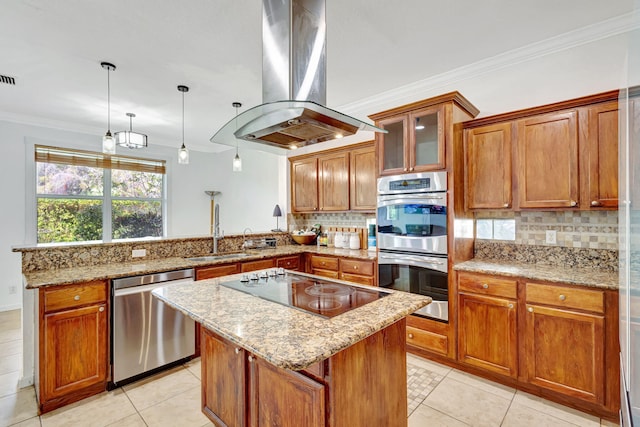 kitchen with a peninsula, a sink, appliances with stainless steel finishes, brown cabinetry, and island exhaust hood