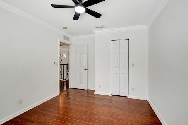 unfurnished bedroom with wood finished floors, visible vents, and baseboards