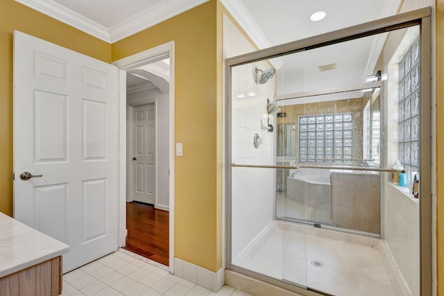 full bath with ornamental molding, tile patterned flooring, a shower stall, and baseboards