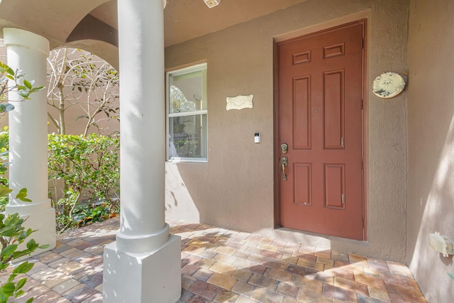 entrance to property with stucco siding