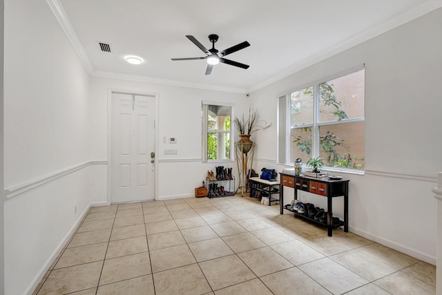 entryway featuring ornamental molding, a ceiling fan, baseboards, and light tile patterned floors