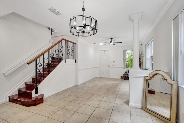 tiled foyer entrance featuring ornamental molding, visible vents, decorative columns, and stairs