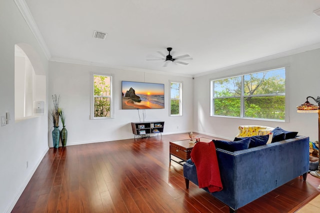 living area featuring ornamental molding, a wealth of natural light, visible vents, and hardwood / wood-style floors