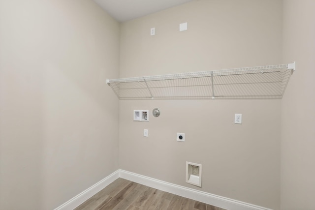 washroom with washer hookup, light wood-style flooring, baseboards, hookup for an electric dryer, and laundry area