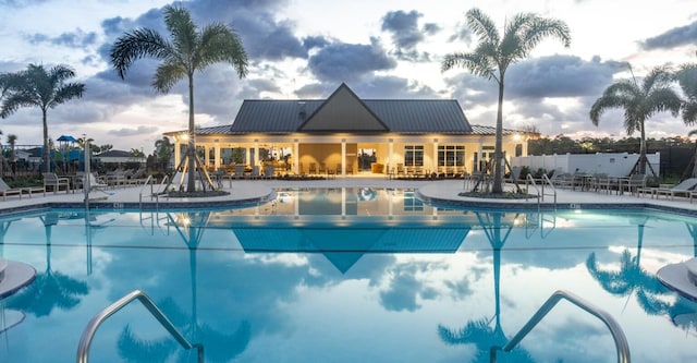 community pool with fence and a patio