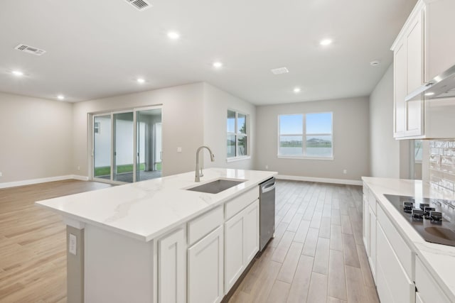 kitchen featuring visible vents, open floor plan, dishwasher, black electric cooktop, and a sink