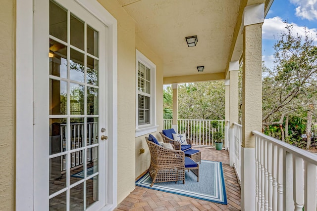 balcony with covered porch and a sunroom