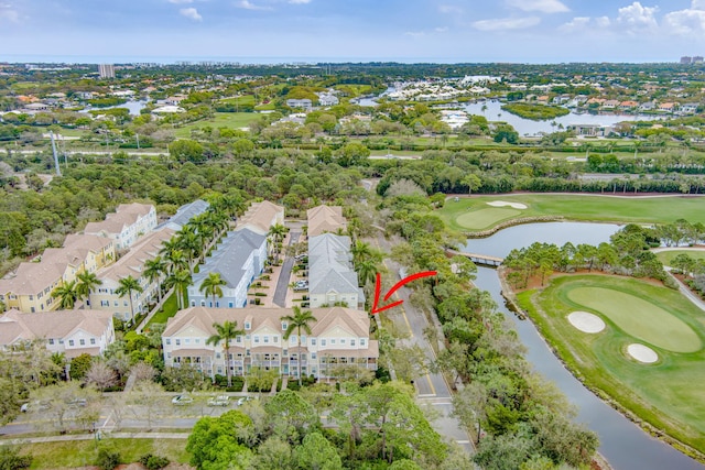 birds eye view of property featuring golf course view and a water view