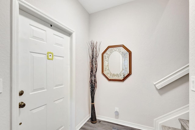 entrance foyer featuring baseboards and wood finished floors