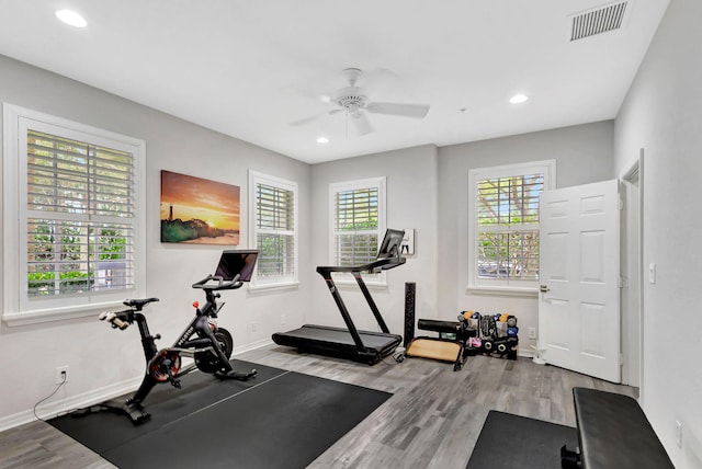 exercise area with light wood-style flooring, visible vents, baseboards, and recessed lighting