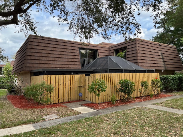 view of front of property with brick siding and mansard roof