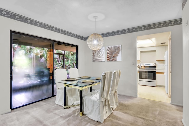 dining space with baseboards and light colored carpet