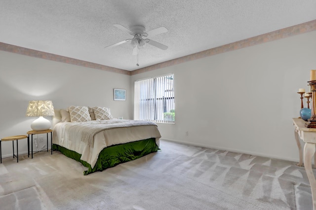 bedroom featuring carpet floors, baseboards, and a textured ceiling